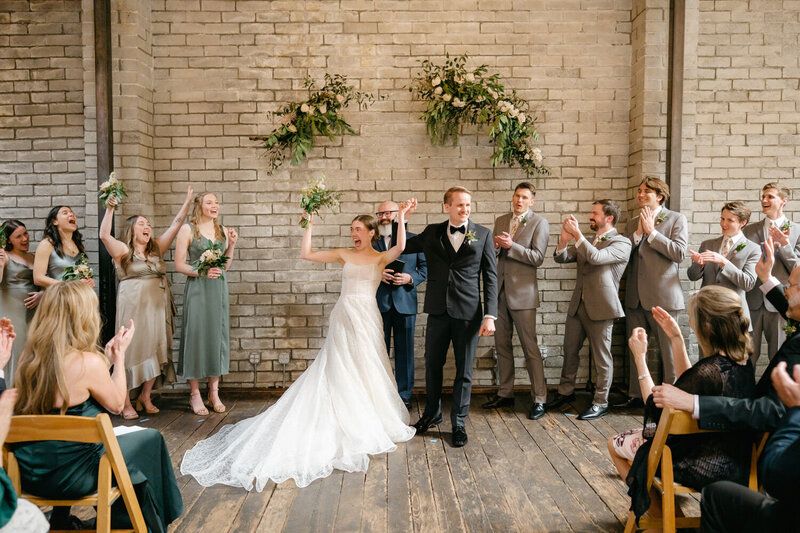 Bridal party celebrates as the wedding concludes