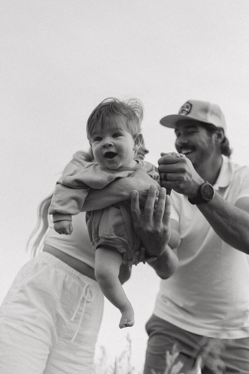 couple holding each other close in front of river