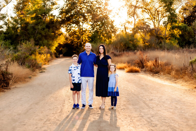 Family Photographer, a family of 4 poses for a photo in San Diego