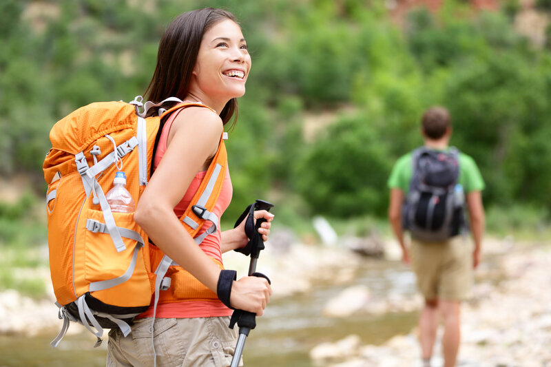 Smiling woman has hiking gear while out hiking in Saint George, Utah