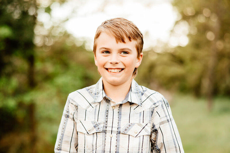 Up close portrait of an 8 year old boy smiling