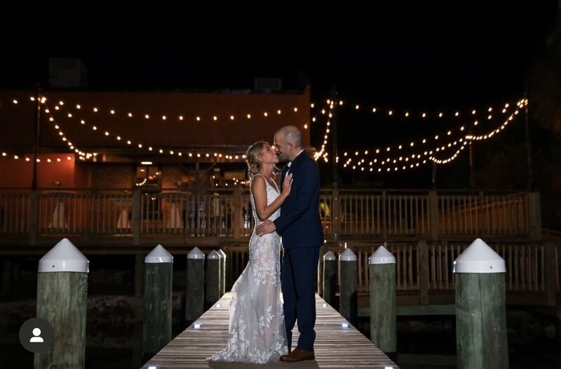 Event Couple on Palafox Wharf Waterfront Pier with cafe lighting in background