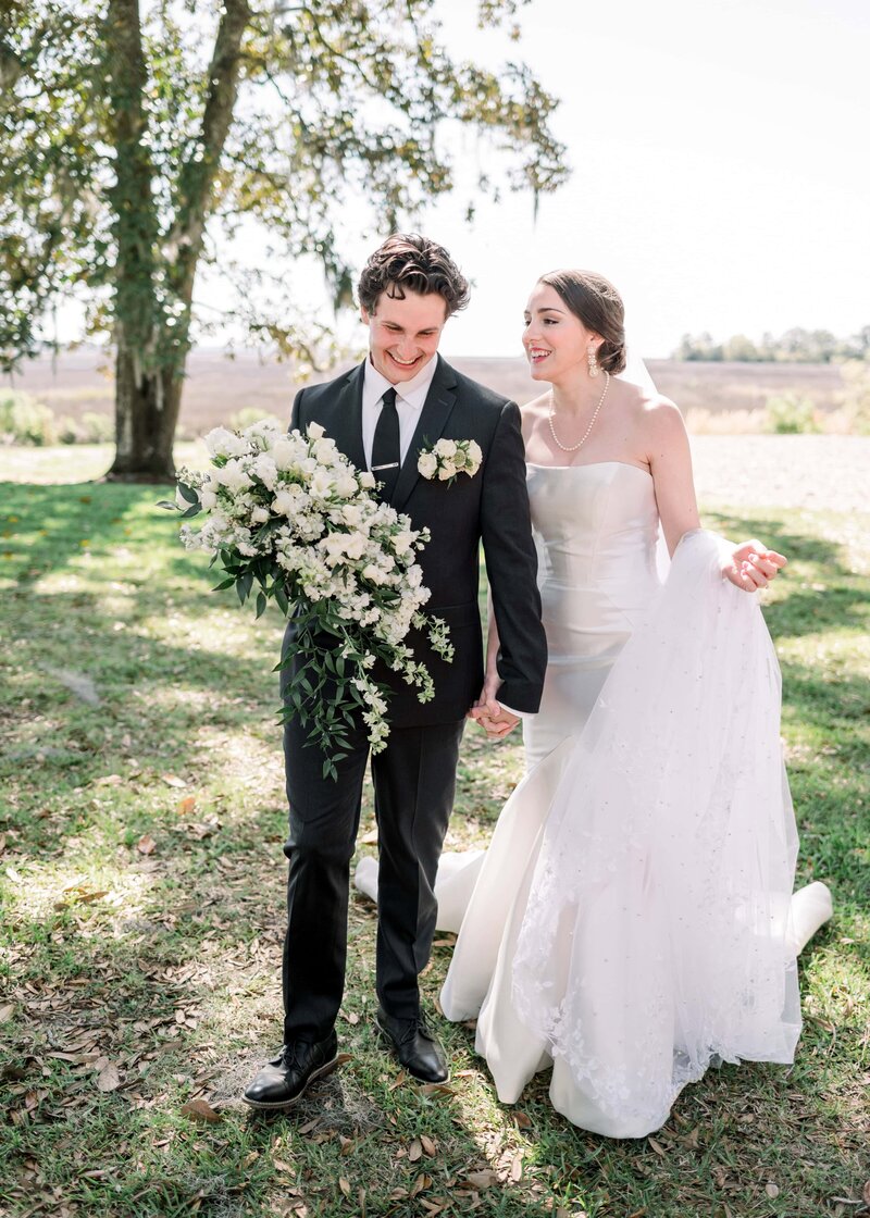 bride and  groom walking by marsh