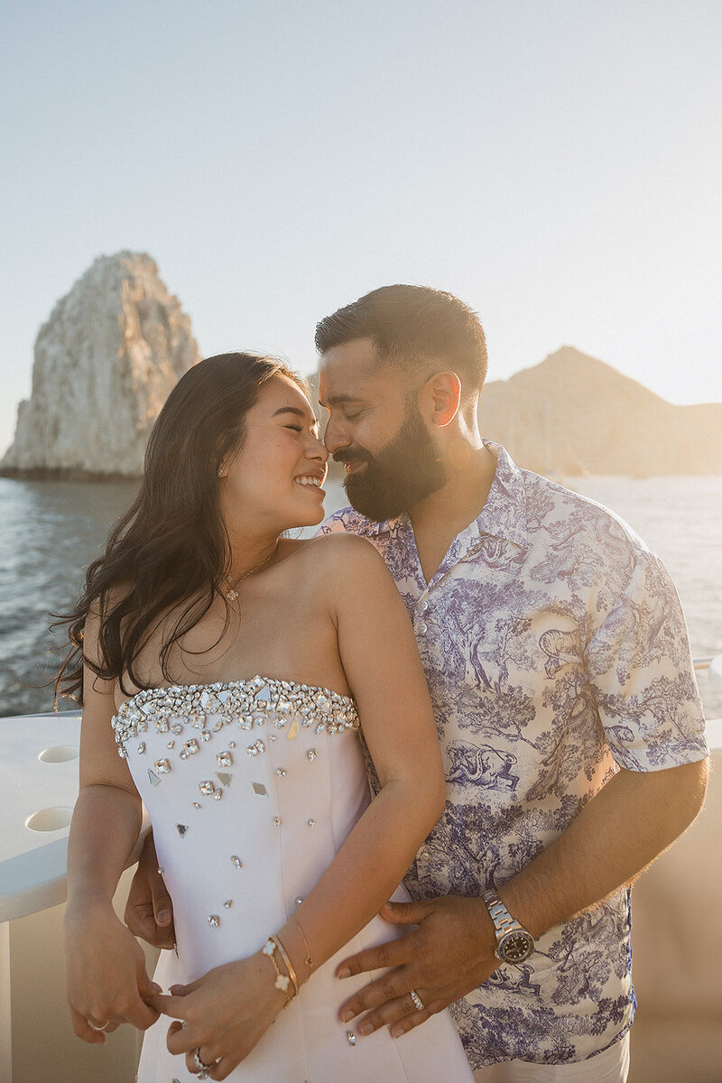 bride and groom on beach smiling on beach