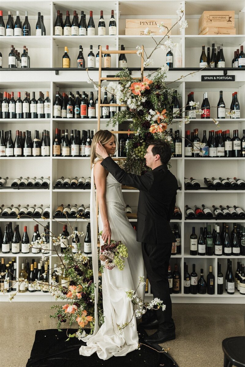 Spring floral installation on wine library ladder with tulips and grapes
