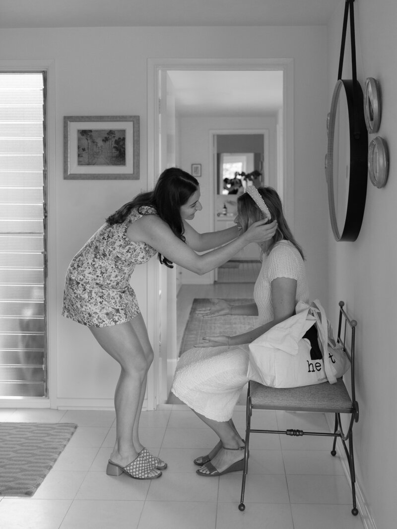 Two women inside a home before a wedding ceremony