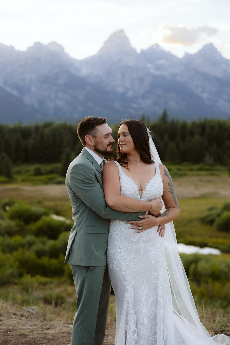 A couple looking into each others eyes laughing in the Sawtooth mountains in Stanley, Idaho