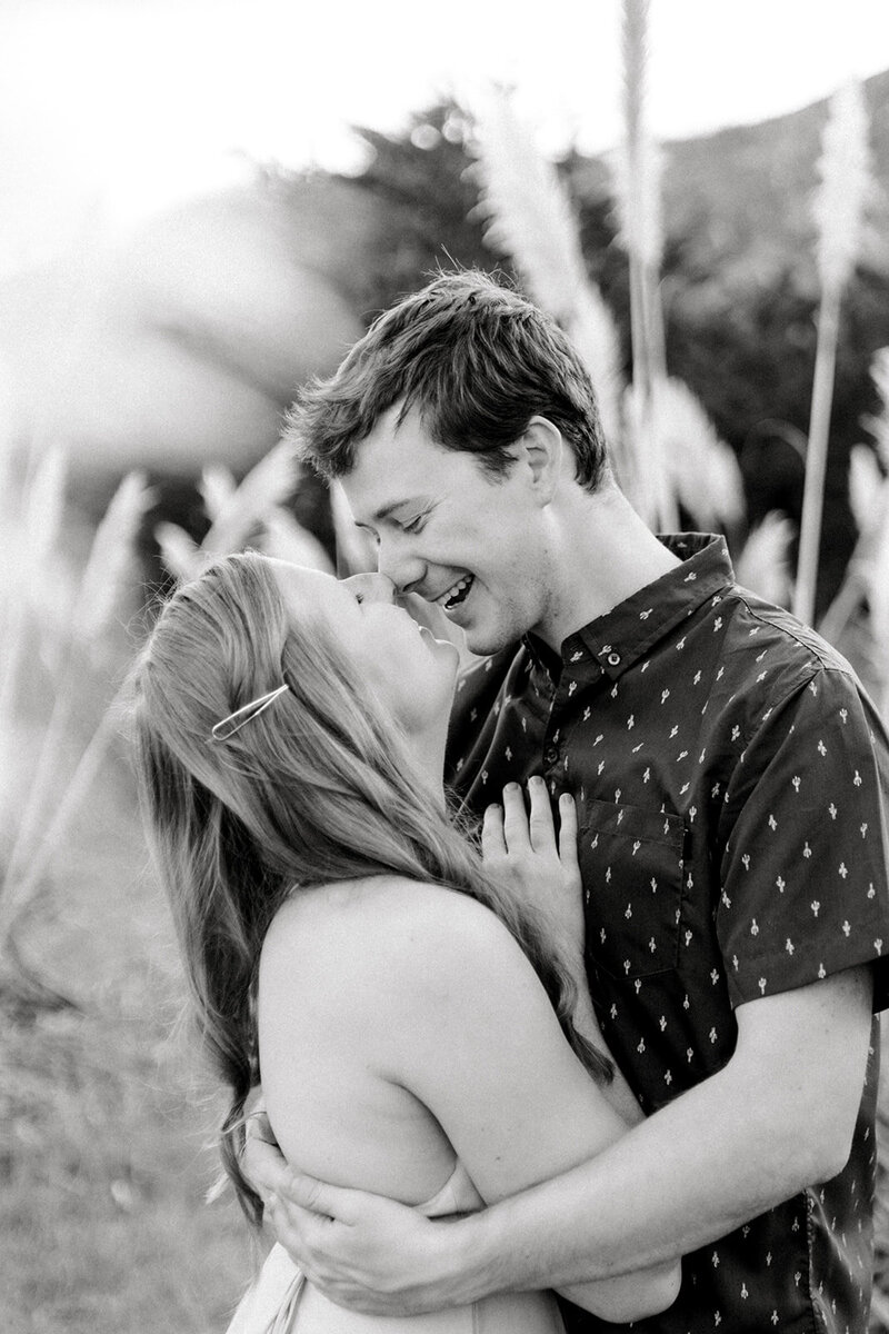 A black and white image of a couple sharing a tender kiss at Lake Tahoe, California, captured by Tiffany Longeway Photography.