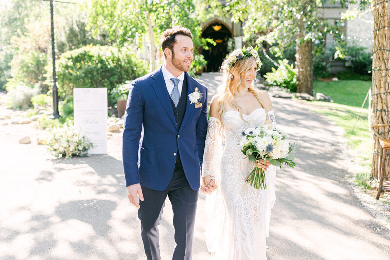 Capture the joyous moment of newlyweds laughing and holding hands as they walk towards their luxury Rolls Royce right after their ceremony. A perfect blend of elegance and happiness on their special day.