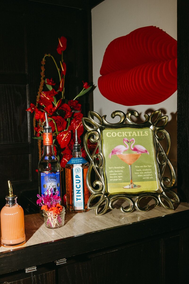 A woman laying on a couch with her legs up working on a laptop.