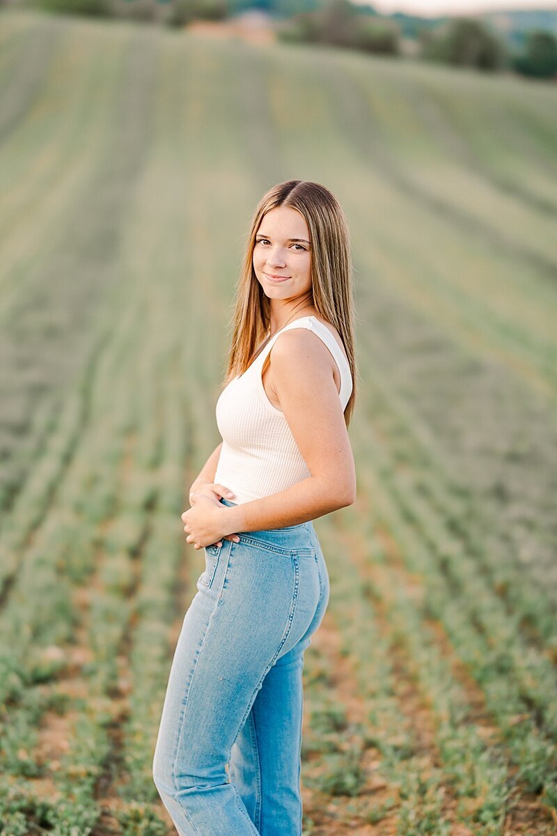 Senior photos at Fort Defiance High School, VA, taken in a scenic field setting, capturing natural beauty and personal style during the graduation session