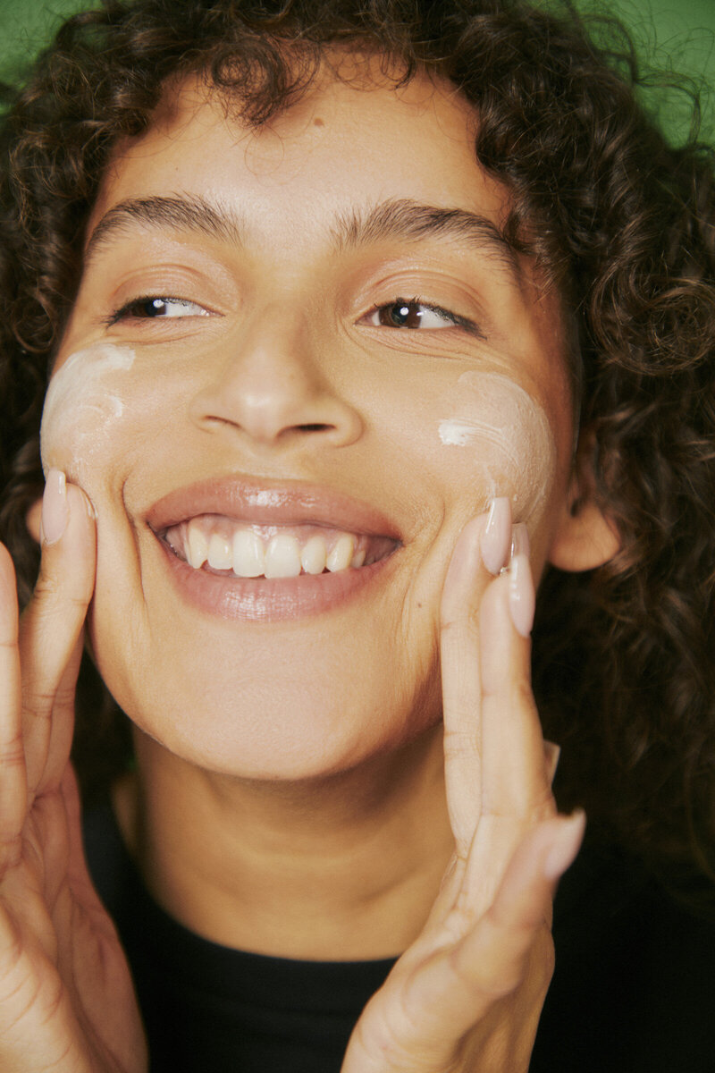 A woman cleaning her skin after a teen facial