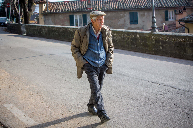 elderly man walking down the street Cortona, Italy