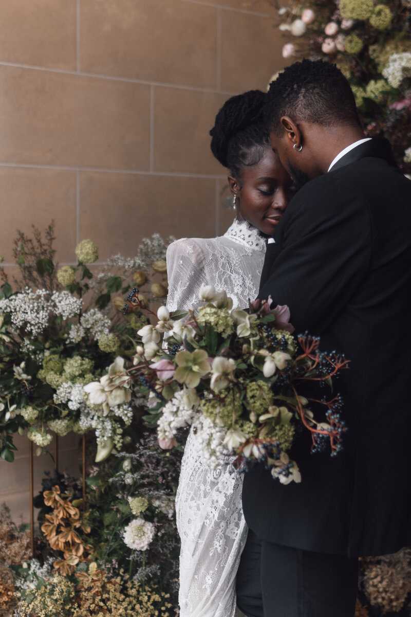 A wedding photographer captures the magical moment of a bride and groom celebrating their wedding ceremony as the bride throws the bouquet in the air