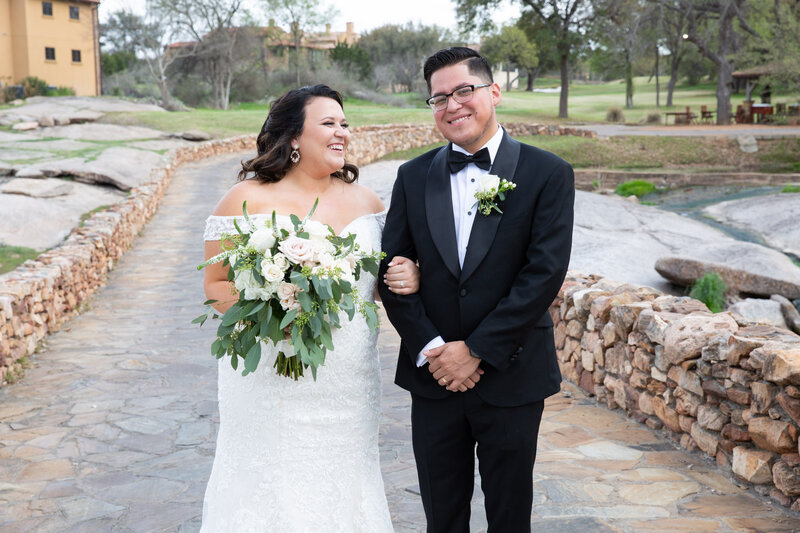 Austin wedding photographer capturing a blissful couple standing on a picturesque stone path.