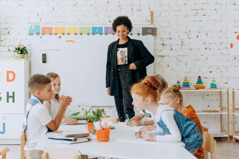 teaching watching over her students coloring at the table