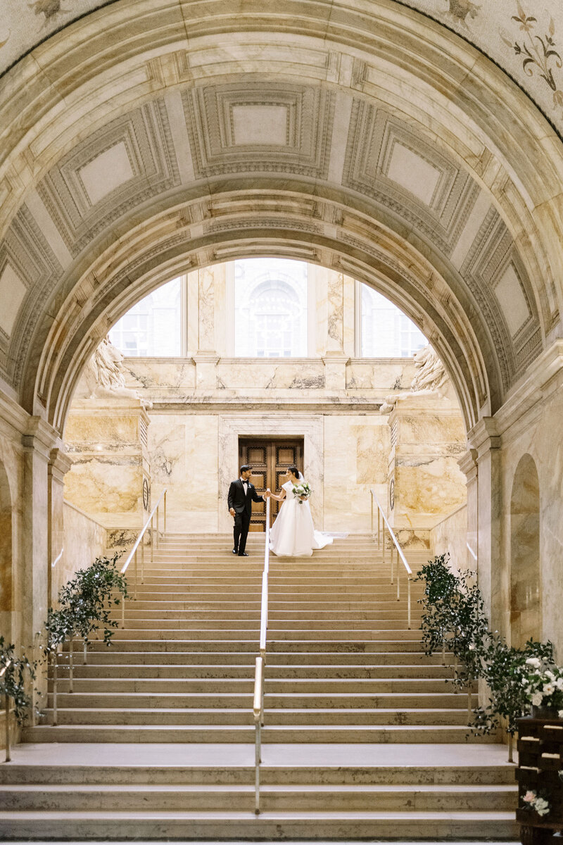 bride and groom portrait on grand staircase at Boston Public Library wedding