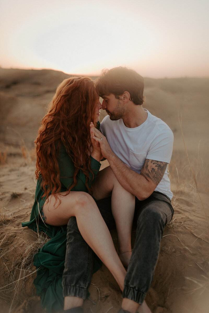 couple sitting embracing in desert
