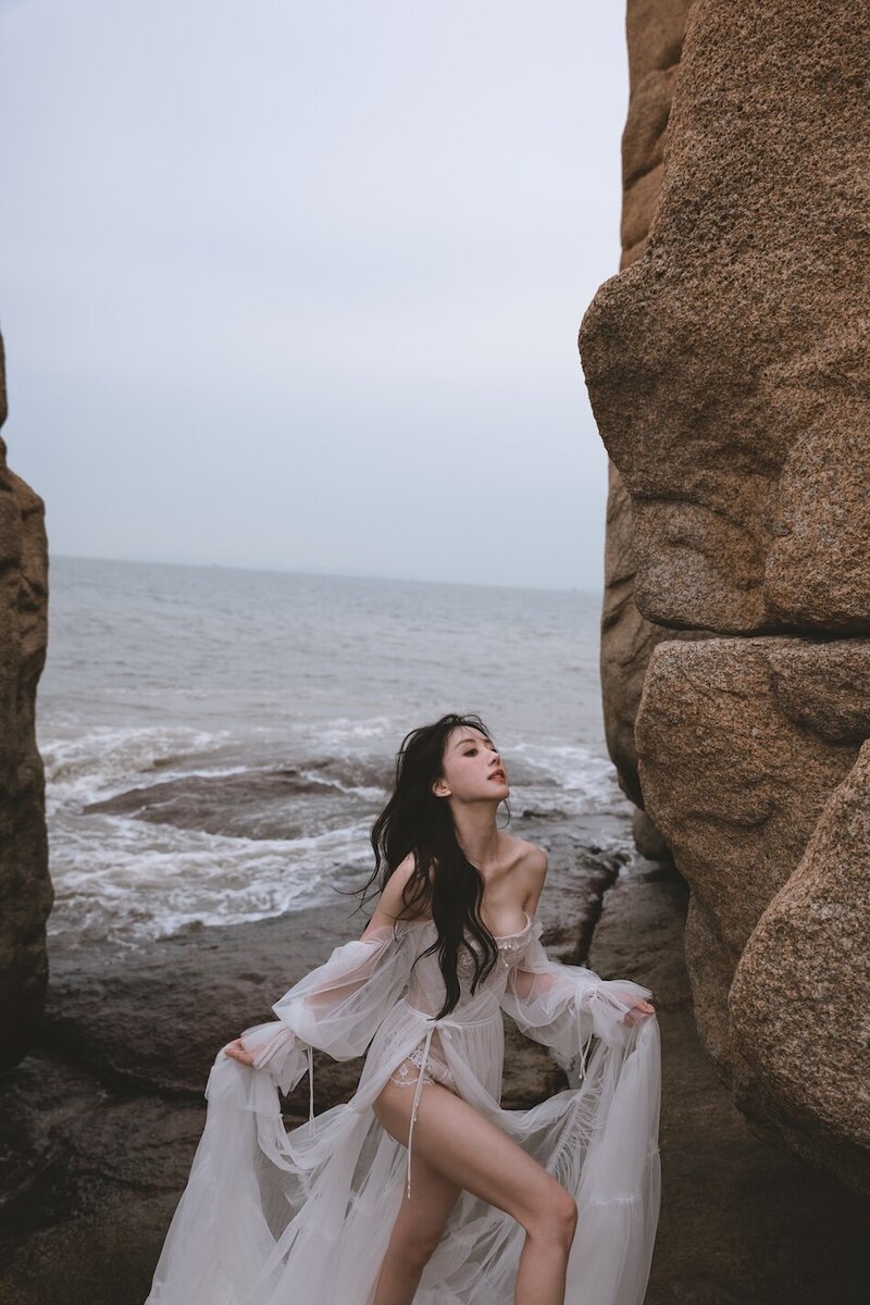 A beautiful windswept beach couture shoot amongst coastal rocks.
