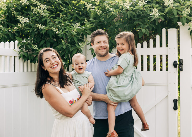 Lifestyle portrait of a laughing family in their backyard in NJ