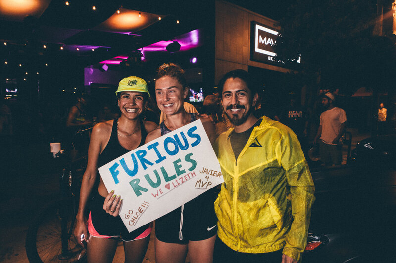 three individual pose for a picture to celebrate a race. 