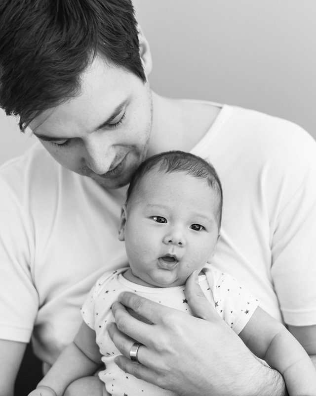 father embracing newborn son against chest, Lynnwood | Meg Sivakumar Photography