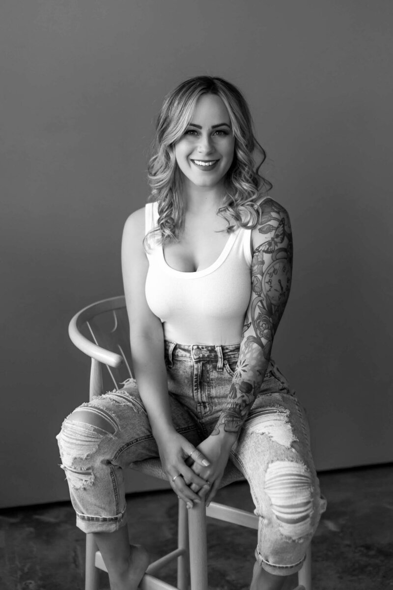 Colorado wedding and boudoir photographer sitting on a chair