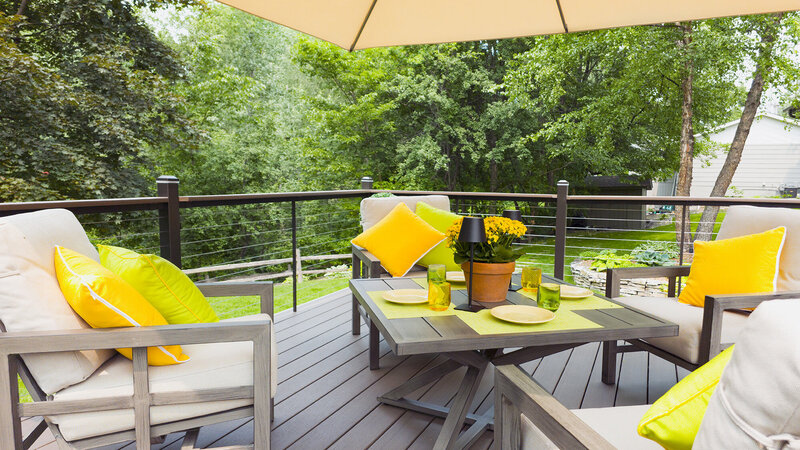 Outdoor seating and table decorated with bright accents. 