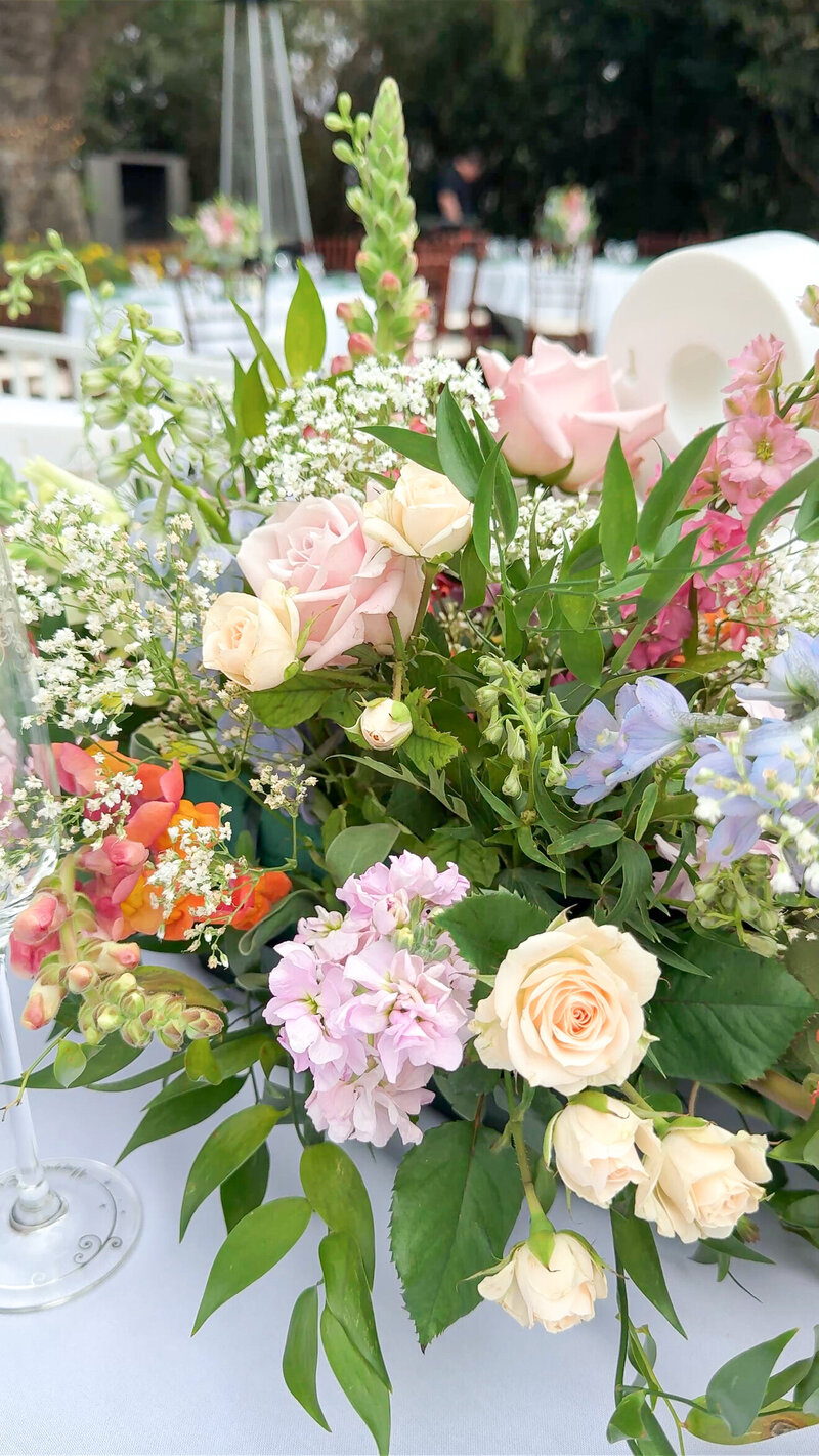 Purple, blue, orange, and pink flowers at a Hawaiian and Native American wedding ceremony at The Orchard Wedgewood Weddings.