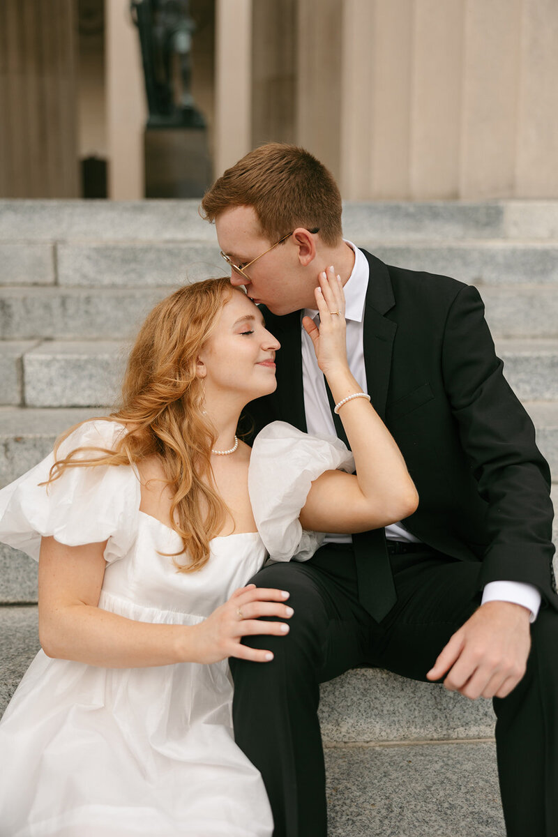 Bride and groom sitting on staircase during downtown Nashville engagement session