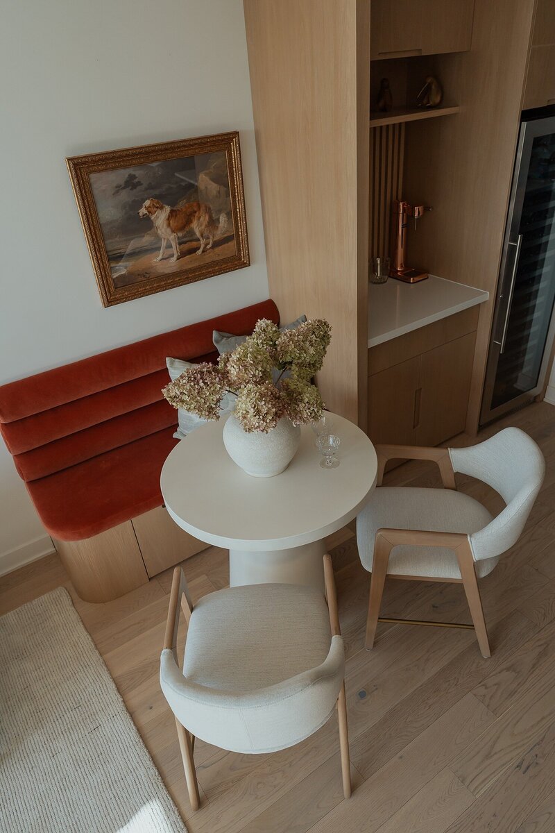 Breakfast nook in condo living room with upholstered bench
