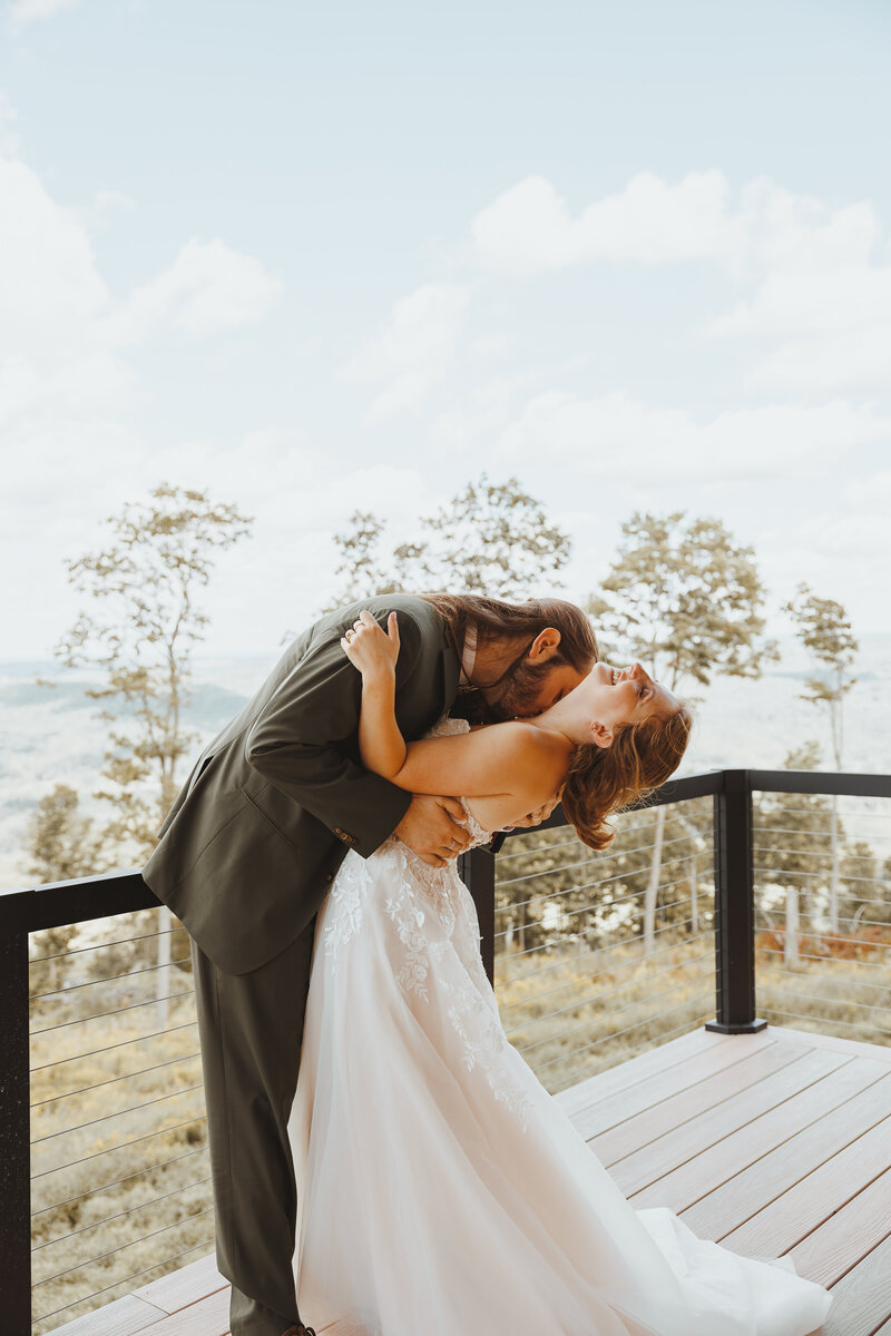 man kissing women neck