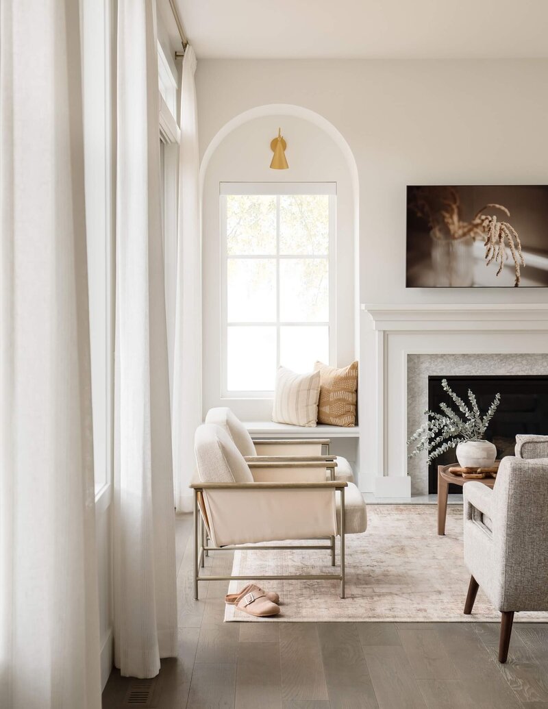 A living room vignette with accent seating, cozy reading corner with accent sconces and pillows. 
