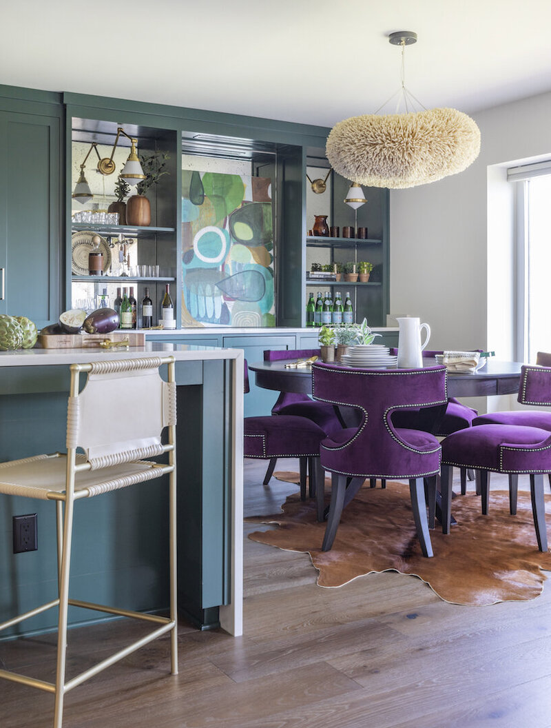 dining room with teal walls and purple chairs