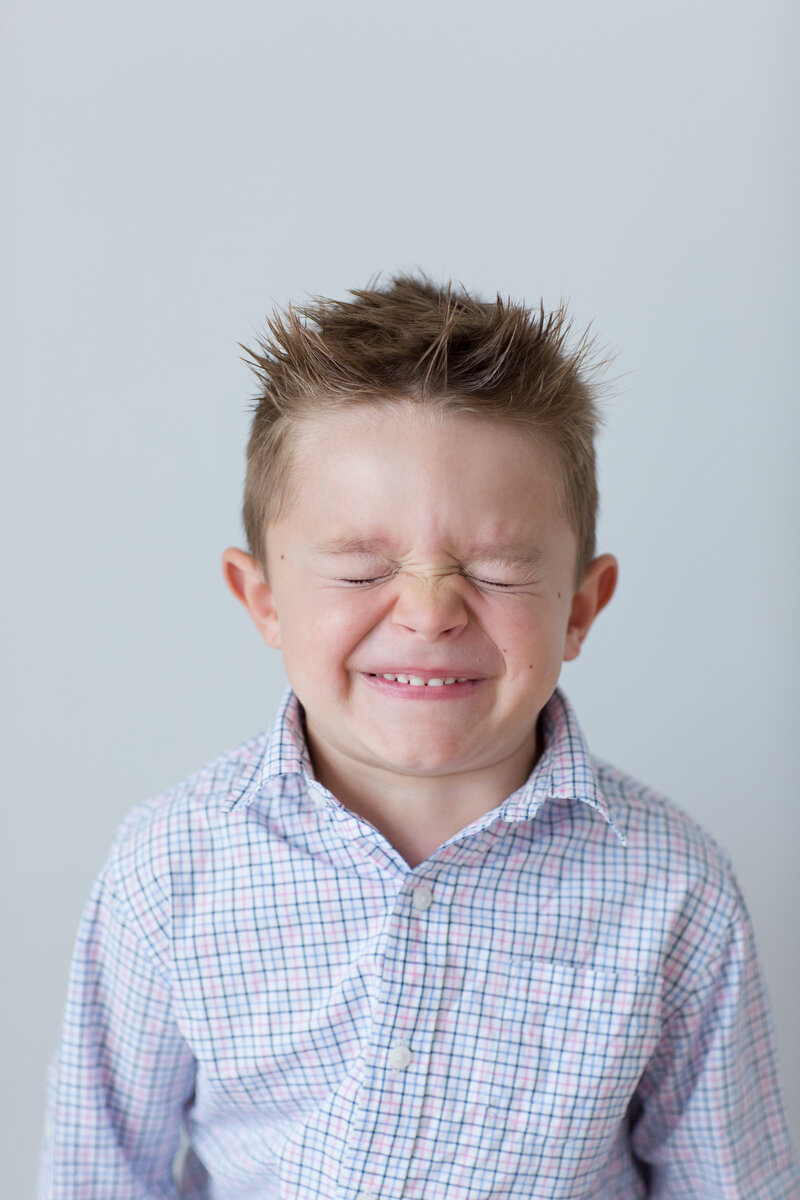 Boy making a cringe face at the camera
