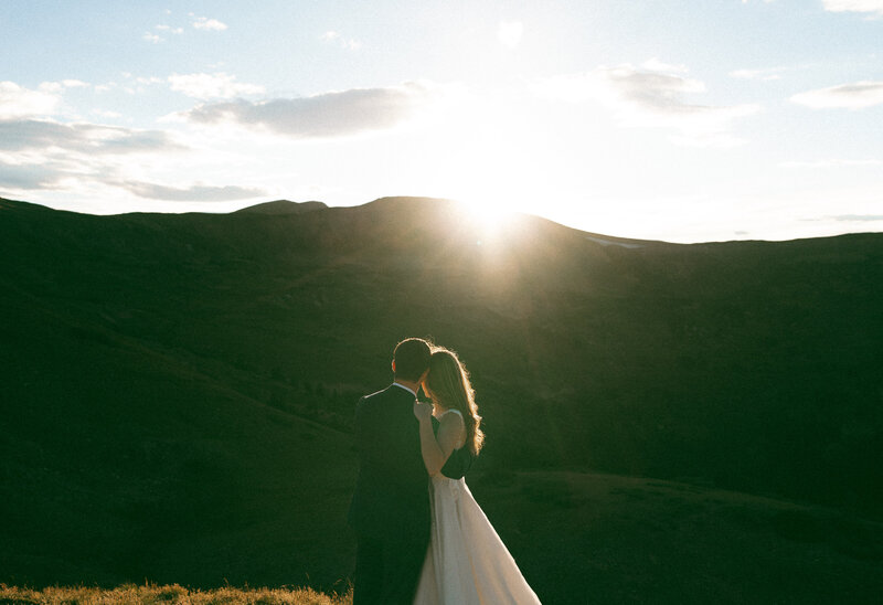 crested butte elopement at sunset, couple looking out at the mountains