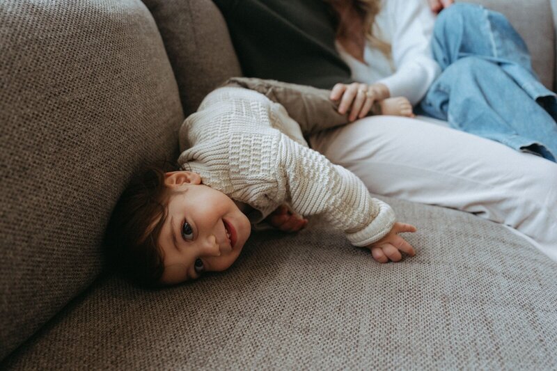 toddler lying on couch during family photoshoot captured by NYC family photographer Elsie Goodman 