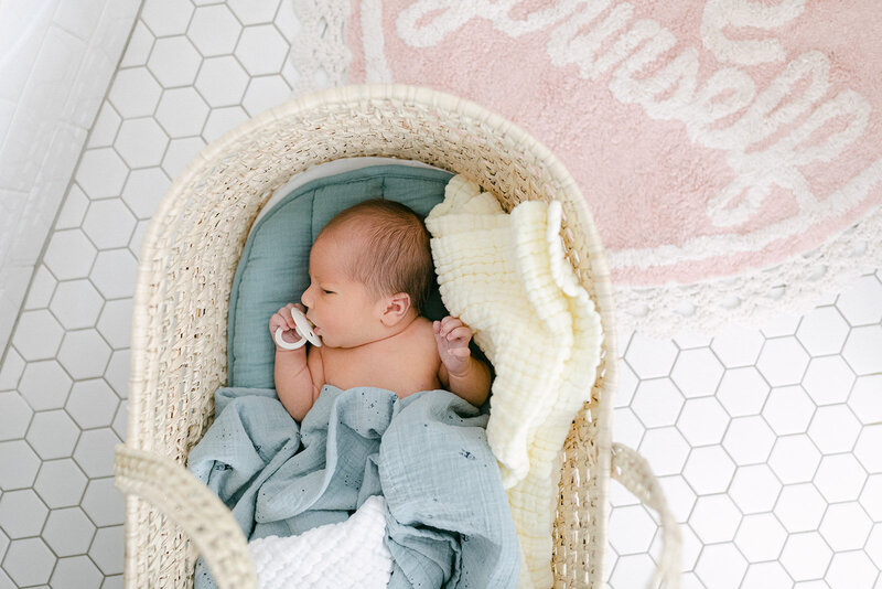 Small baby laying in a bassinet