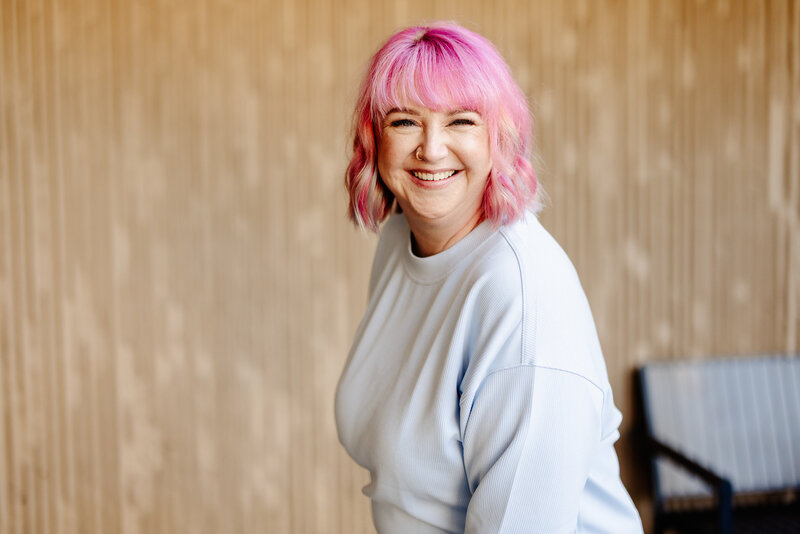 Ashley Ebert smiles while teaching a session to grow your wedding business