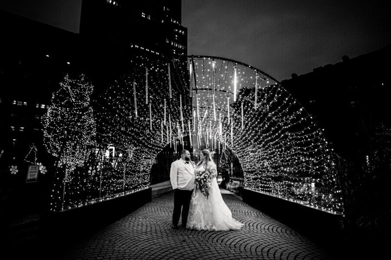 bride and goom in downtown cleveland wedding photography black and white under christmas lights