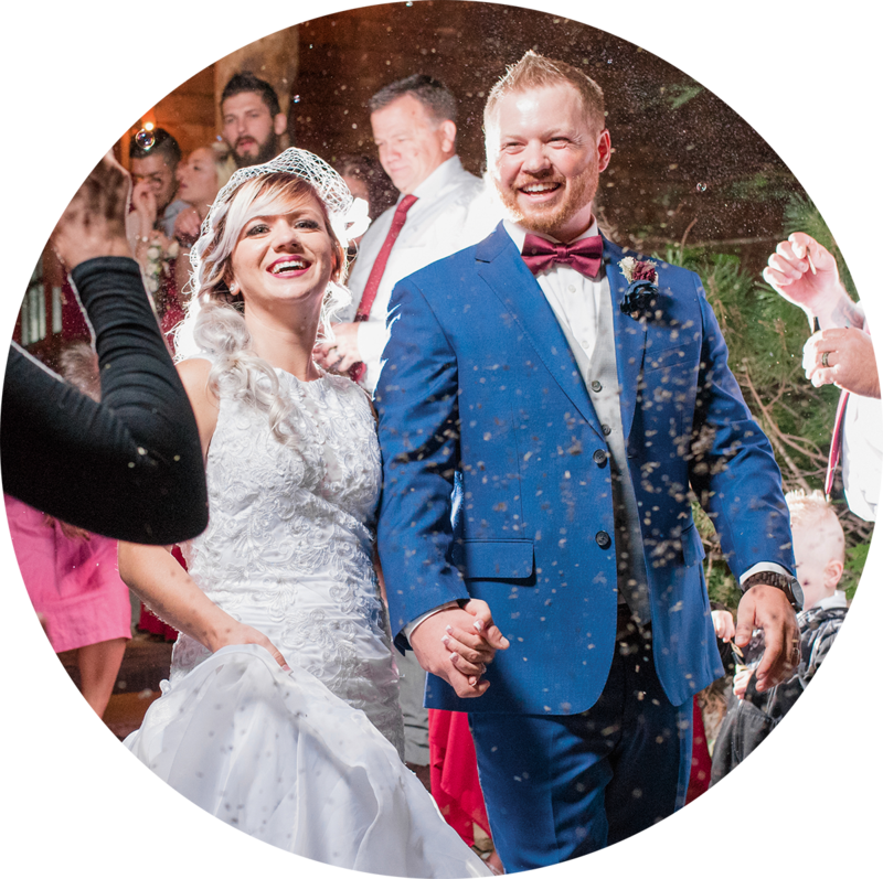 bride and groom laughing during bubble sendoff at Log Haven