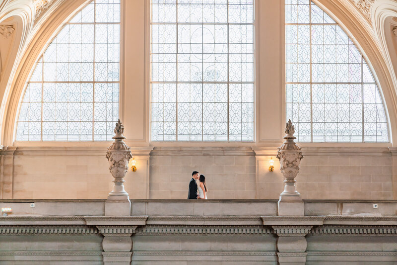 bride and groom holding hands on the stairs of the City Hall - San Francisco - 4Karma Studio