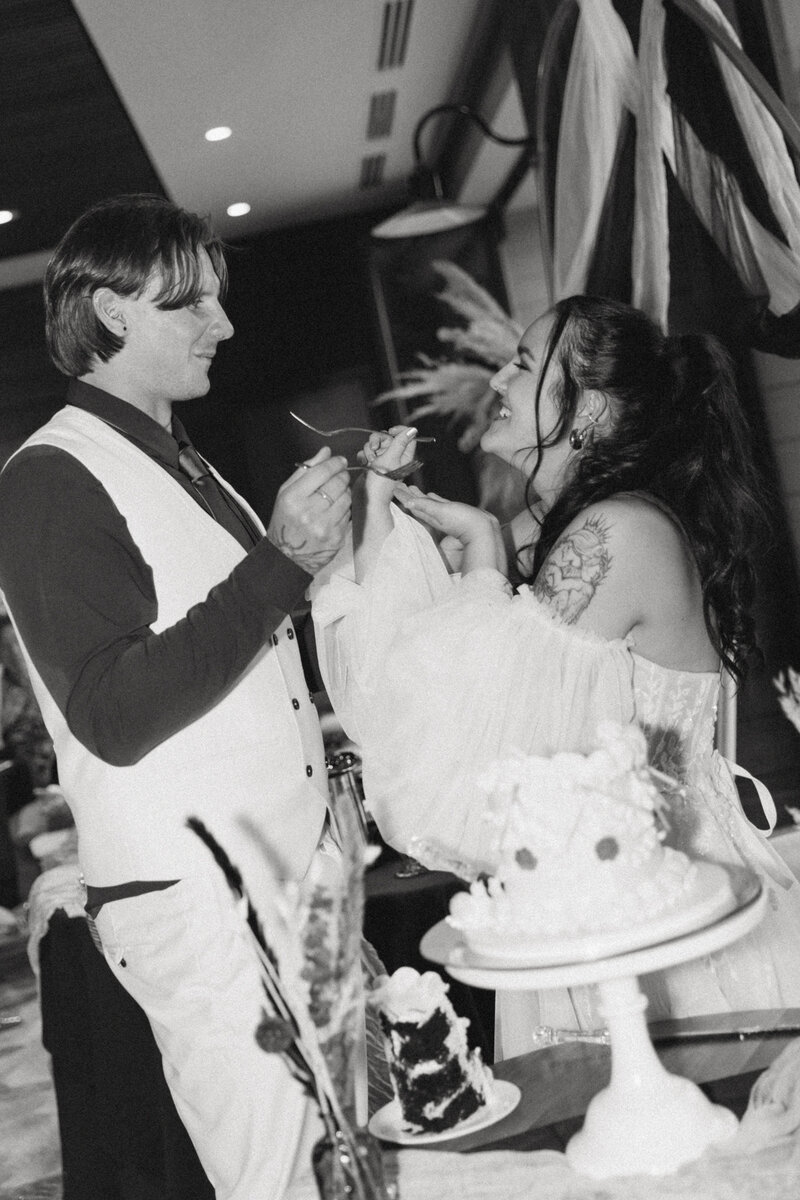 bride and groom captured during cake cutting by alberta wedding photographer