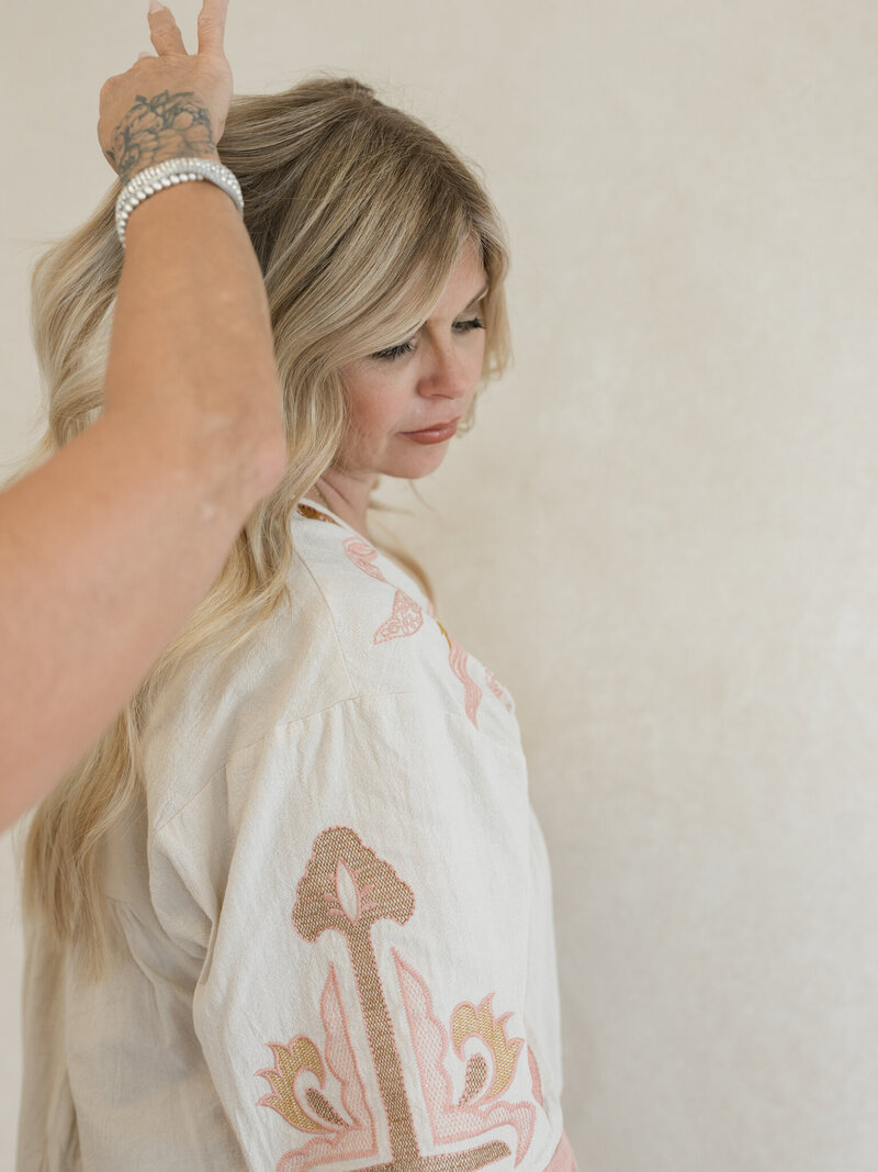 hair stylist styling clients hair extensions