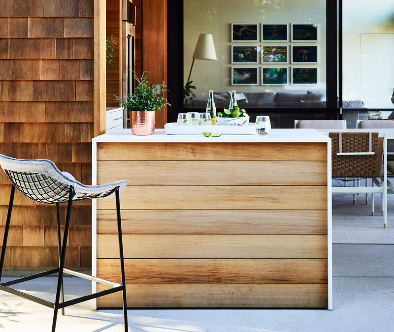 Modern interior decorators Hingham Boston new construction pool house features a custom drink bar with red cedar cabinetry and clean modern detailing.