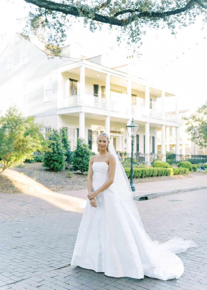 bride smiling in wedding dress with veil