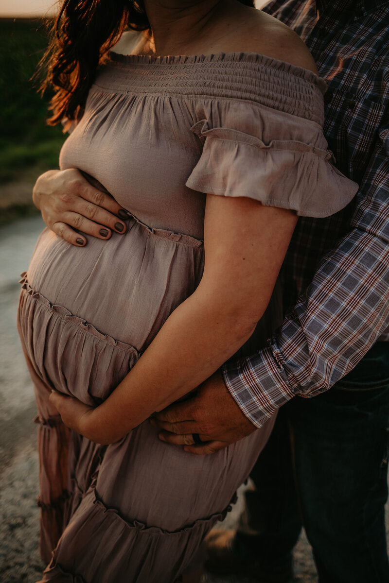 COUPLE HOLDING BABY BELLY