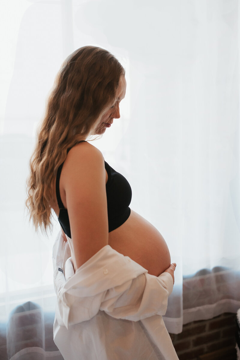 Young couple posing with an ultrasound for Lizee Gardner, an Idaho maternity photographer