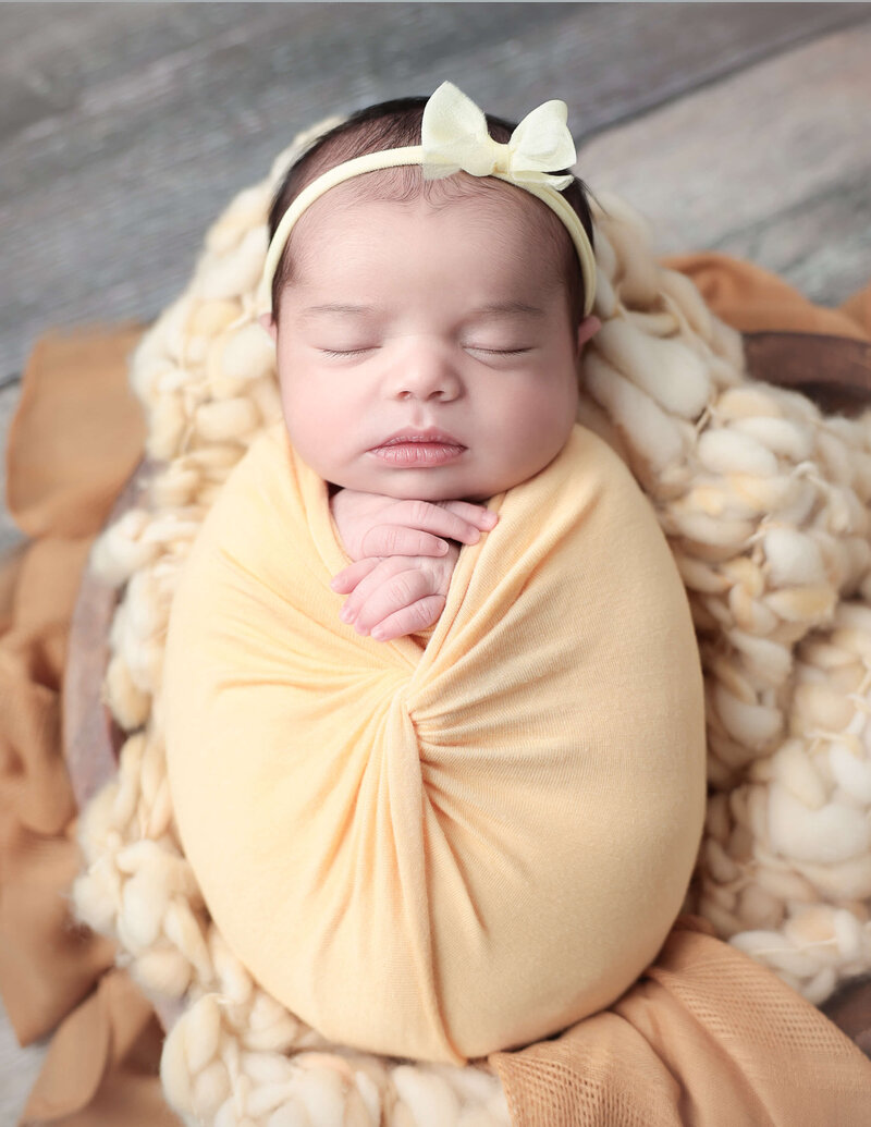 Adorable baby girl wrapped at our Hilton Ny studio.