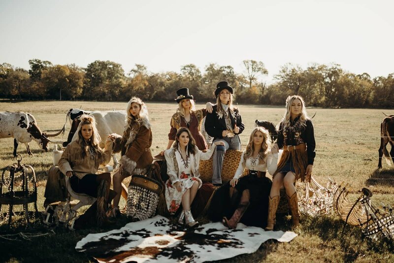 Women modeling western wear in a field